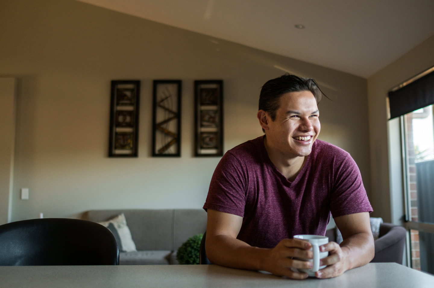 Person in kitchen holding mug