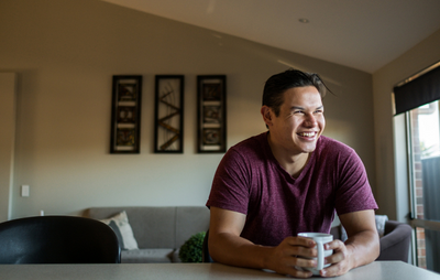 Person in kitchen holding mug