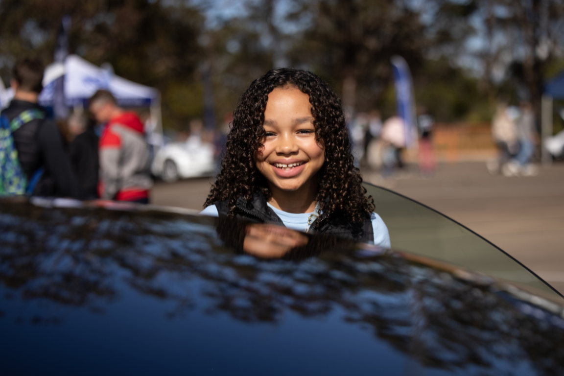 Child outside electric vehicle