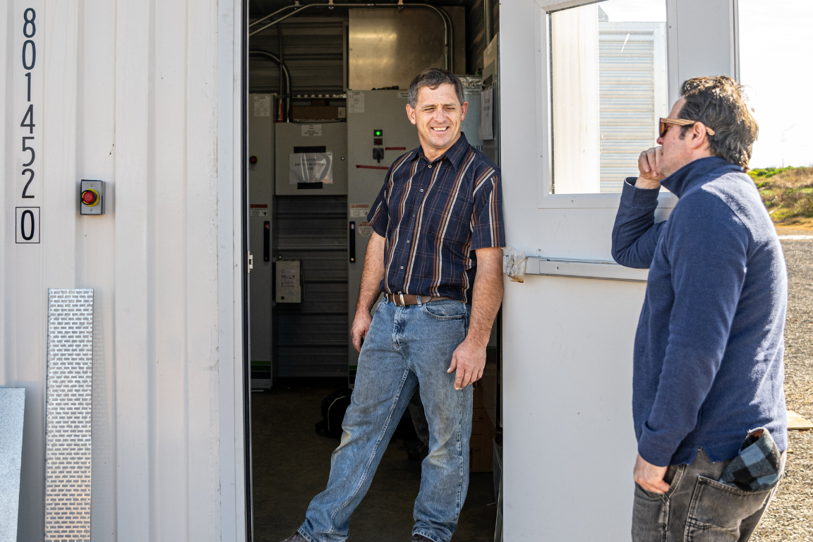 Construction colleagues talking outside a site office