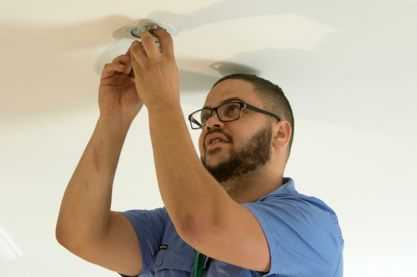 Tradesperson installing energy efficient lighting