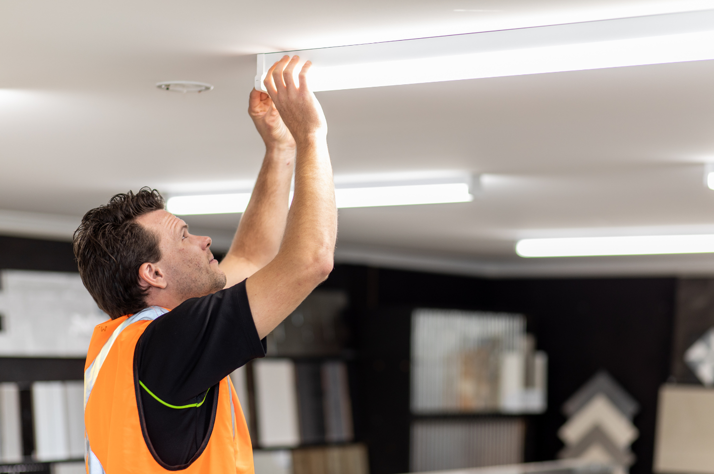 Tradesperson installing energy efficient lighting