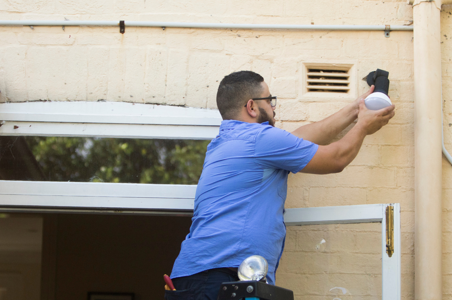 Tradesperson installing energy efficient lighting