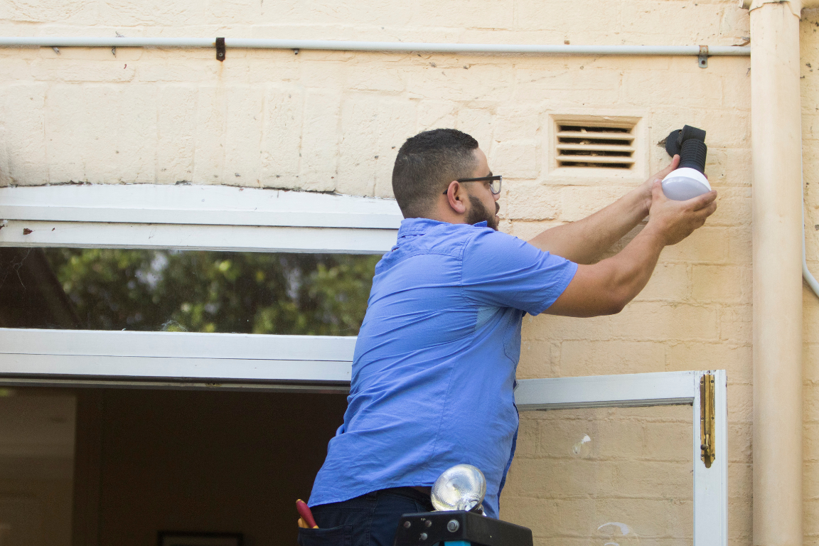 Tradesperson working on outdoor light