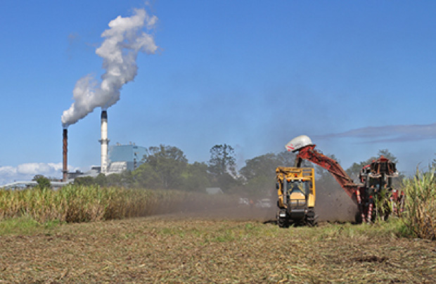 Broadwater Sugar Mill - field with machinery in foreground and factory in background
