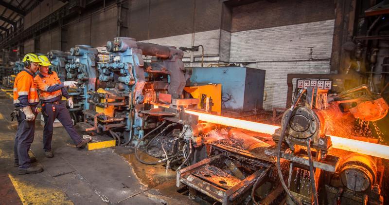 Factory workers with furnace equipment