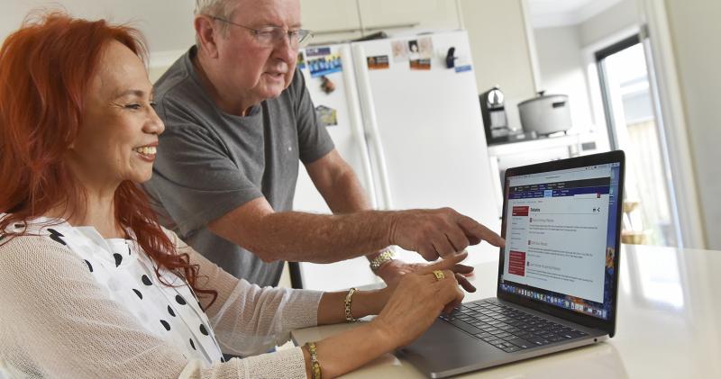 Couple looking at energy rebates on laptop