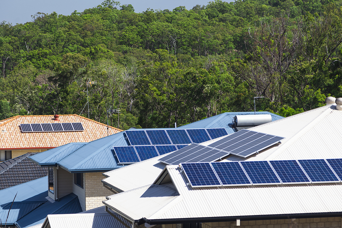 A row of house roofs with solar panels