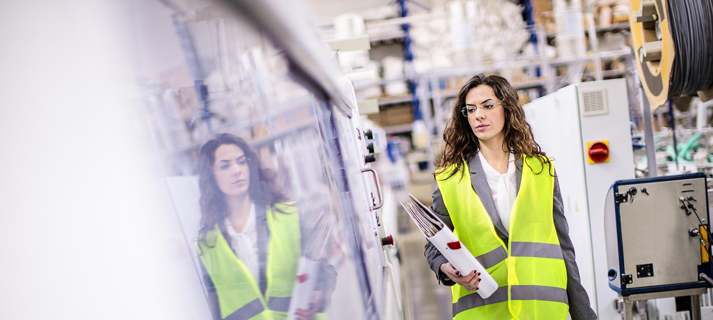 Female worker walking through factory