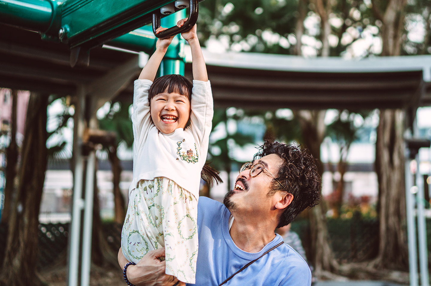 Adult and child on play equipment