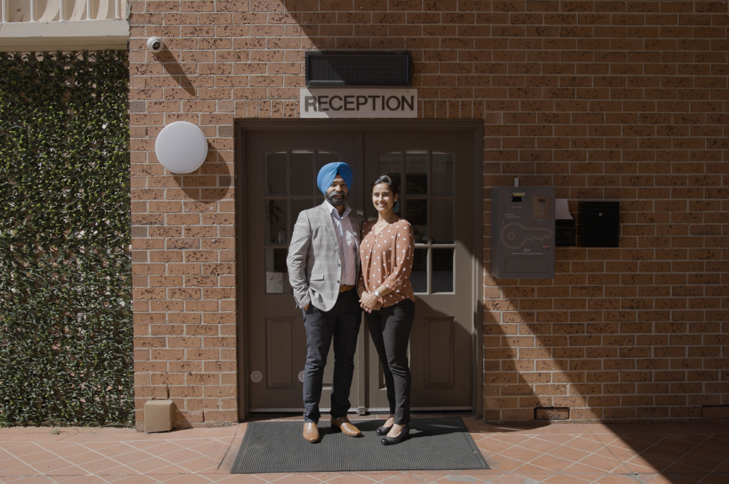 Moteliers standing outside reception