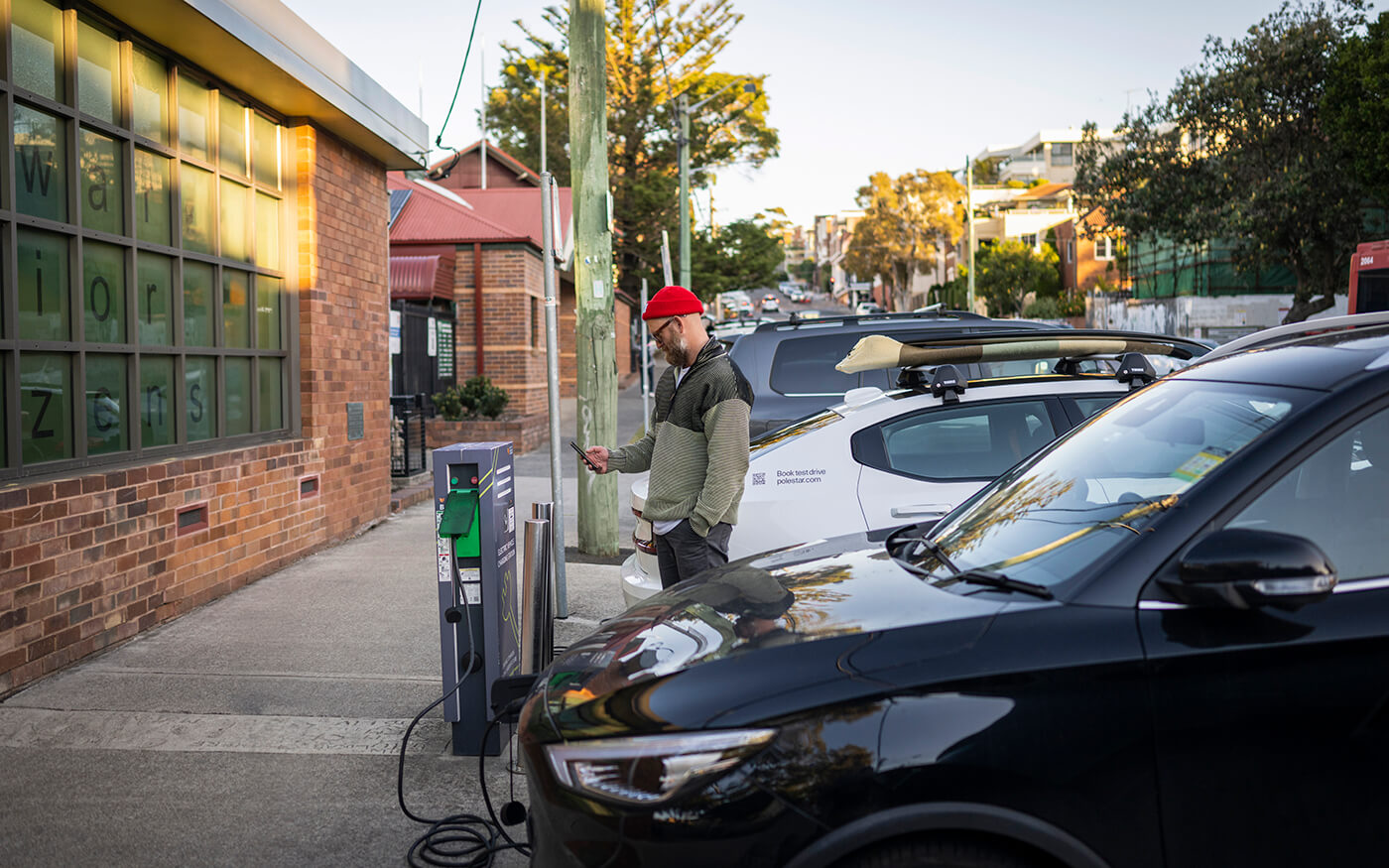 Person using kerbside electric vehicle charger