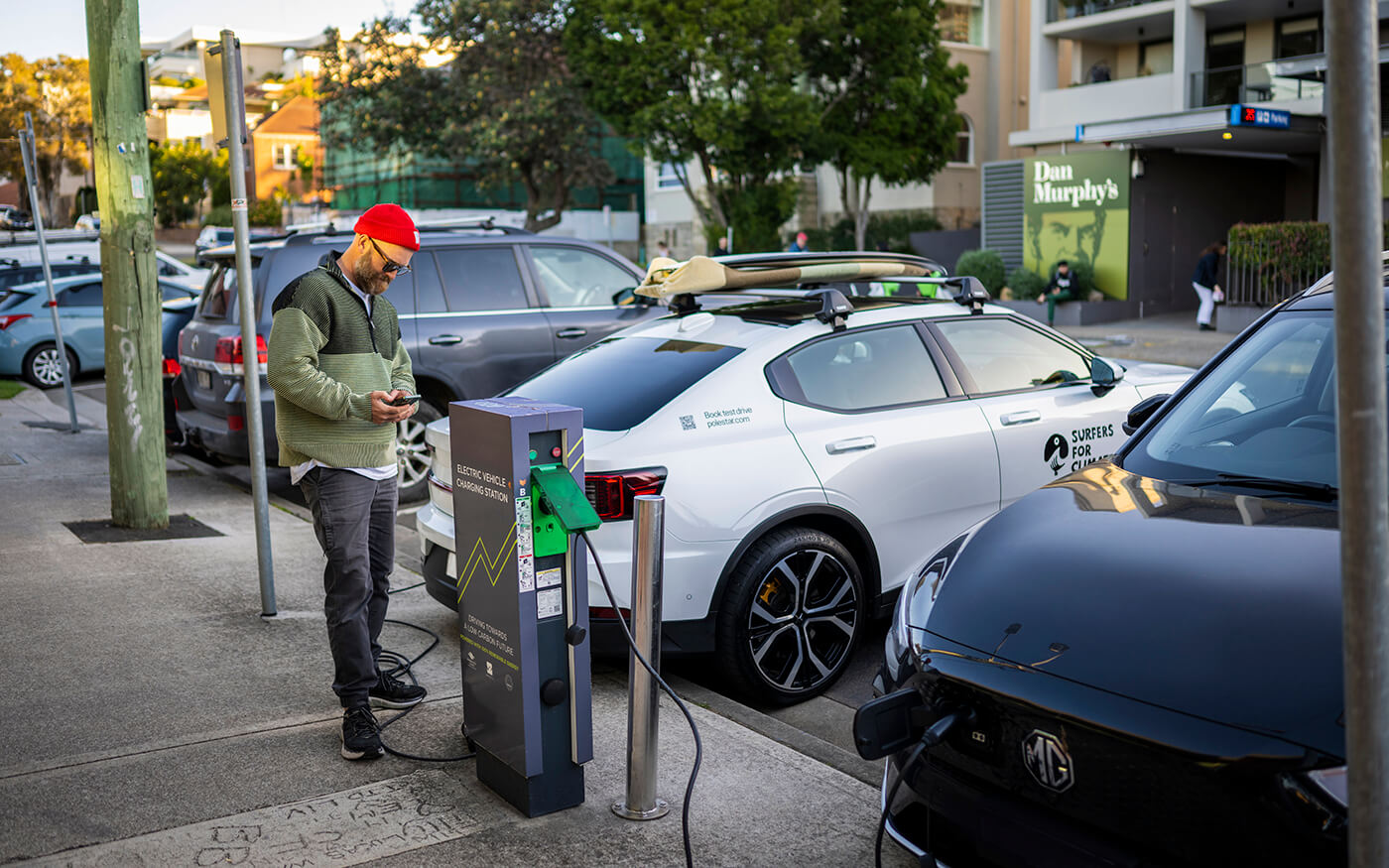 Person using kerbside electric vehicle charger