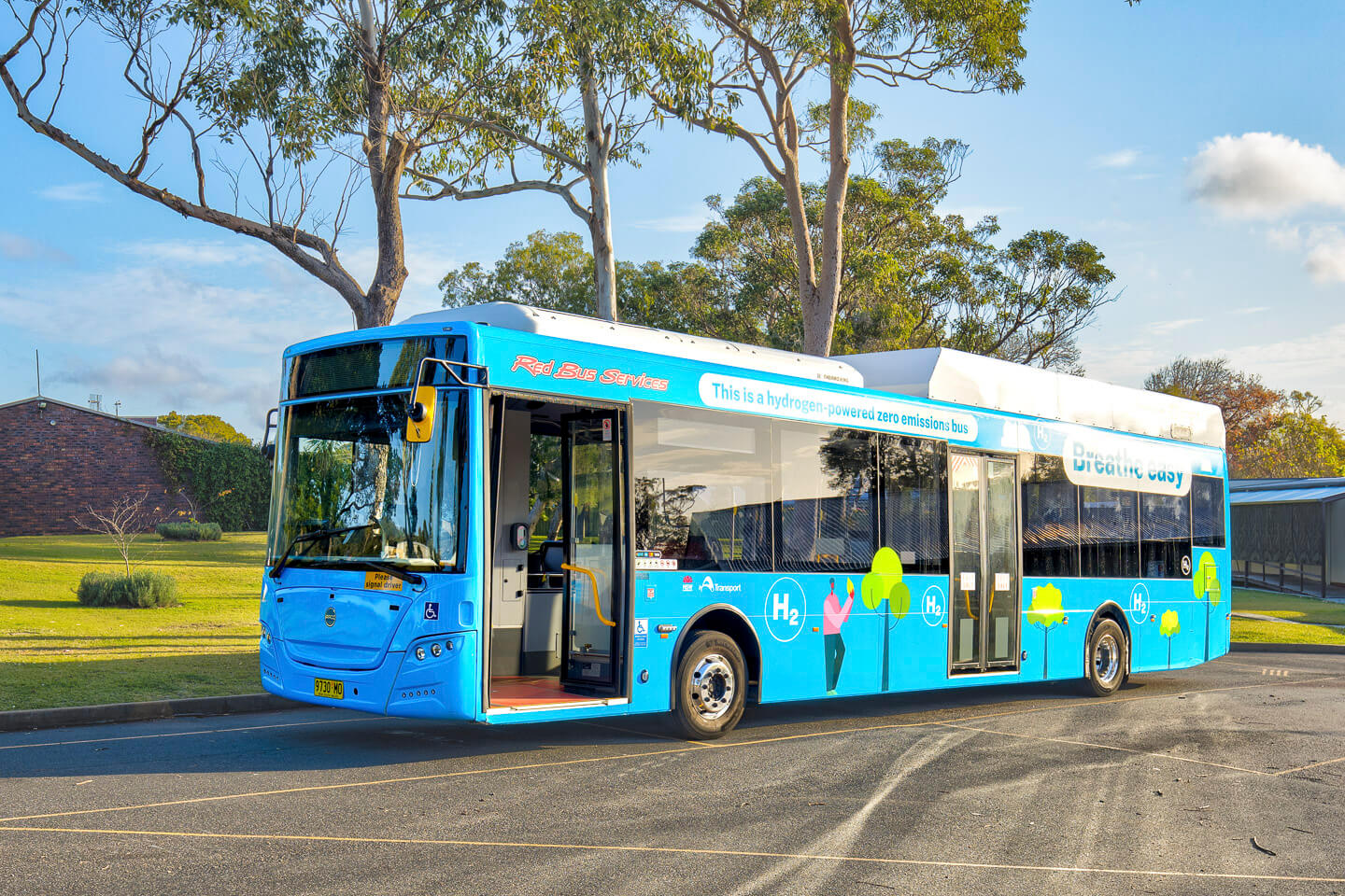 Hydrogen bus in front of gum trees