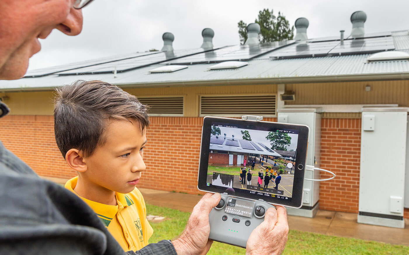 Teacher and student using technology to look at solar panels