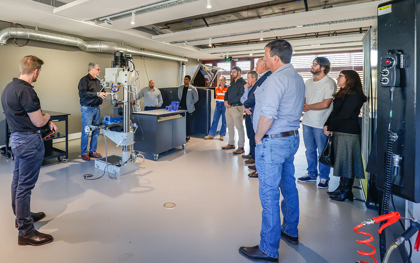 Group of people looking at machinery