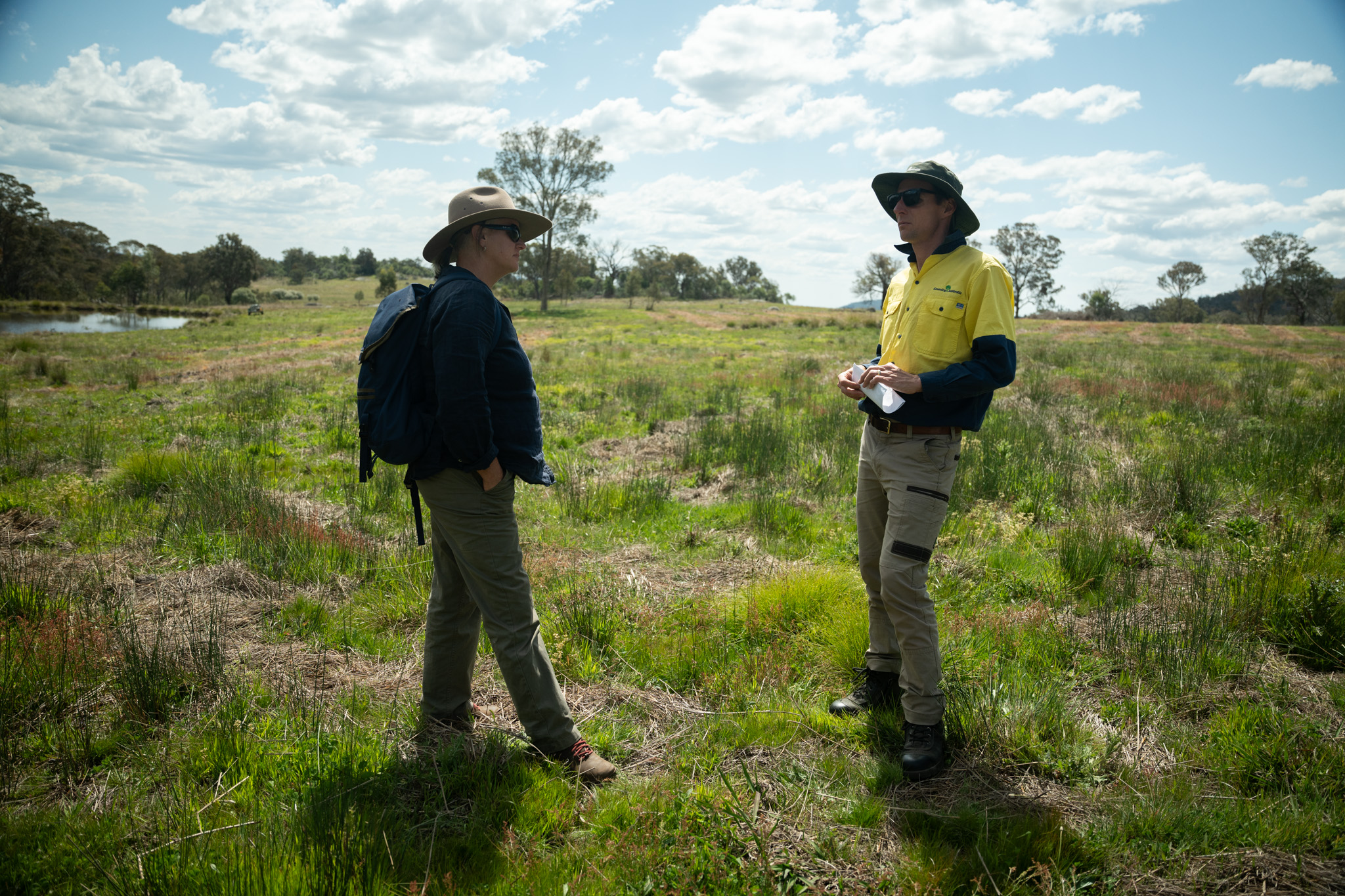 Two people standing in a field