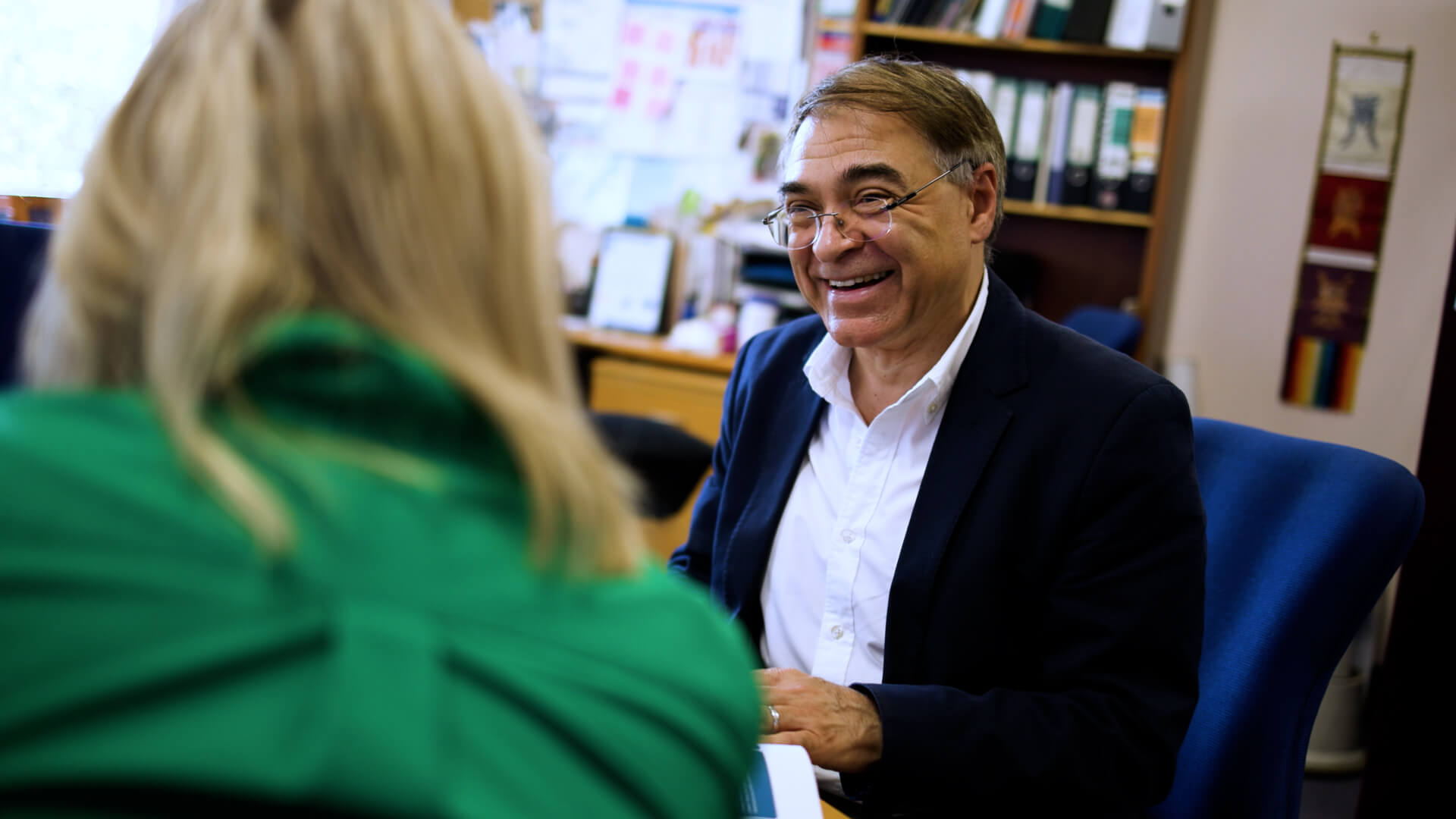 A man and a woman talking inside an office