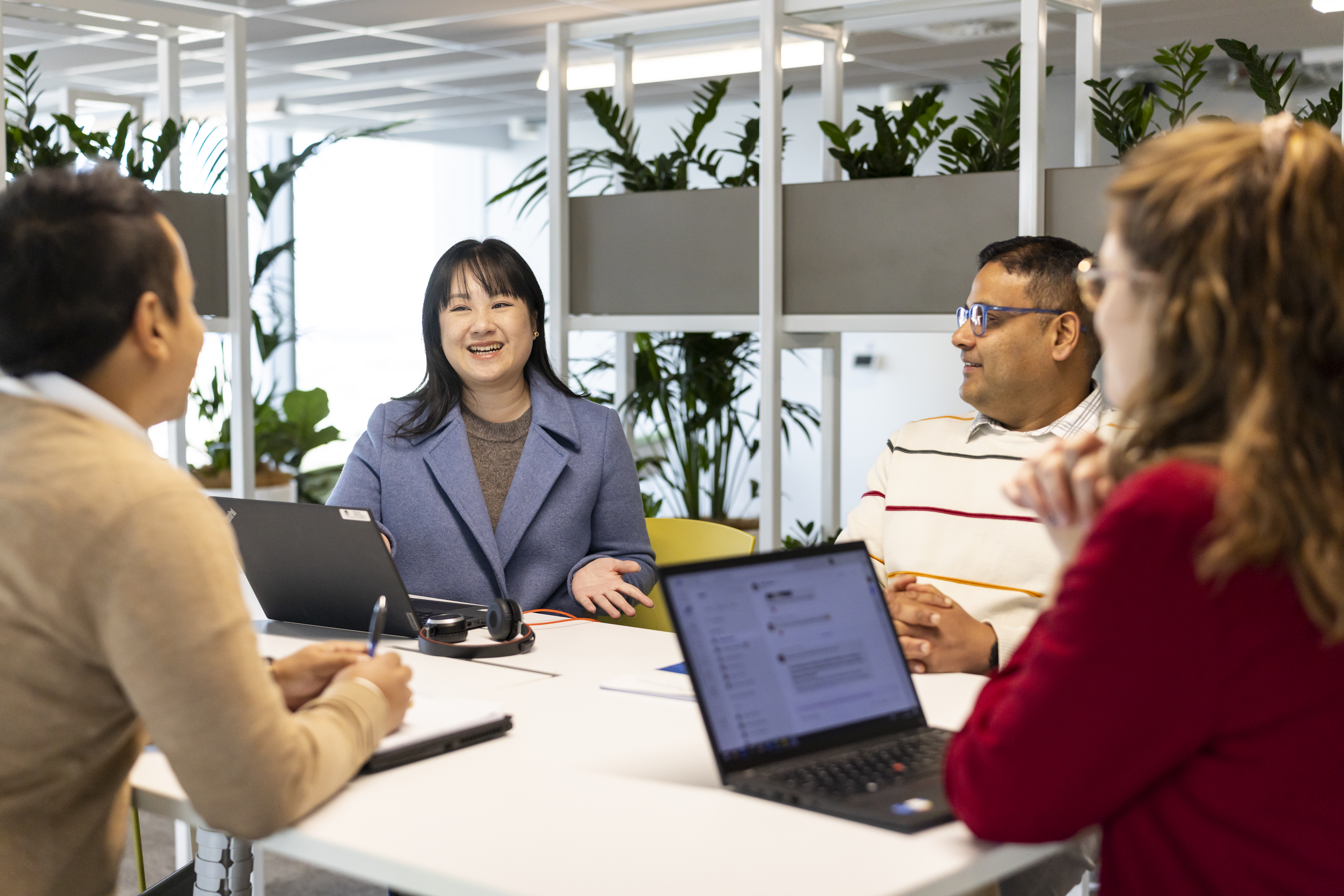 Team of people having a meeting with their laptops open