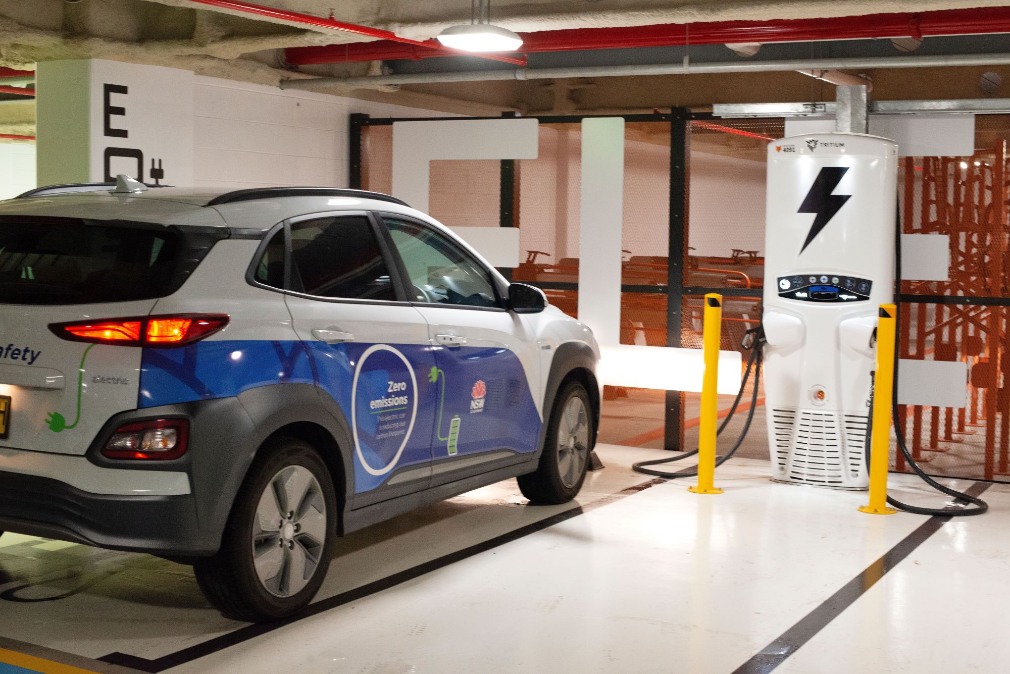 NSW Government branded electric vehicle plugged in charging