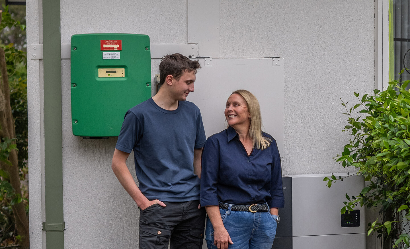 2 people standing in front of a battery