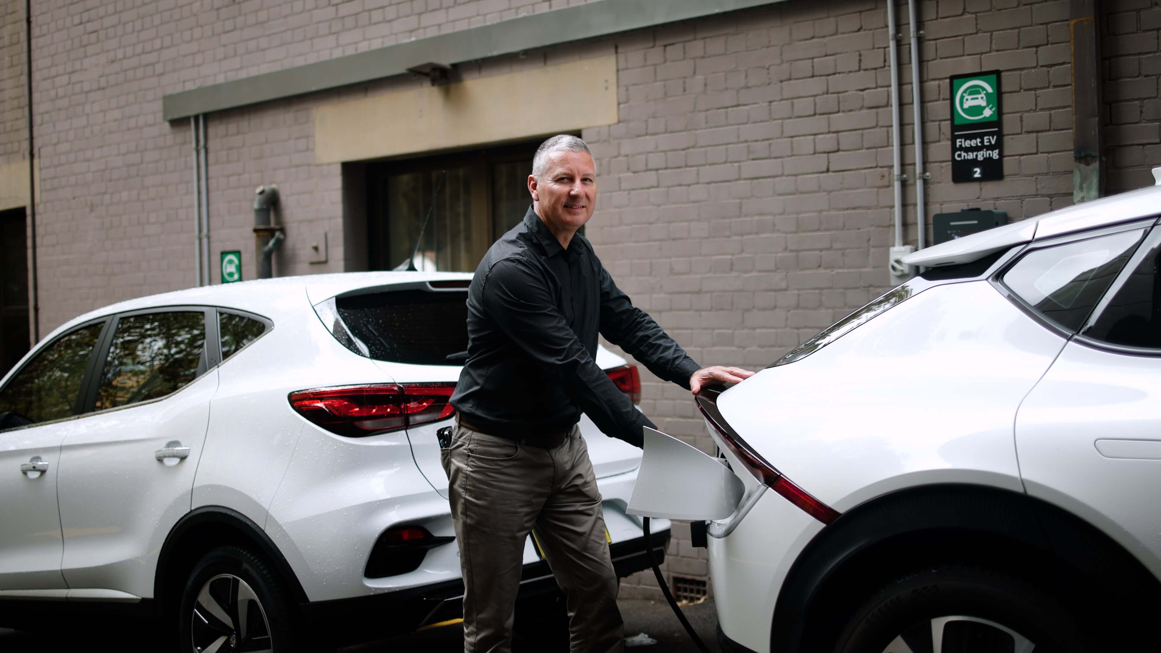 A man charging his electric vehicle