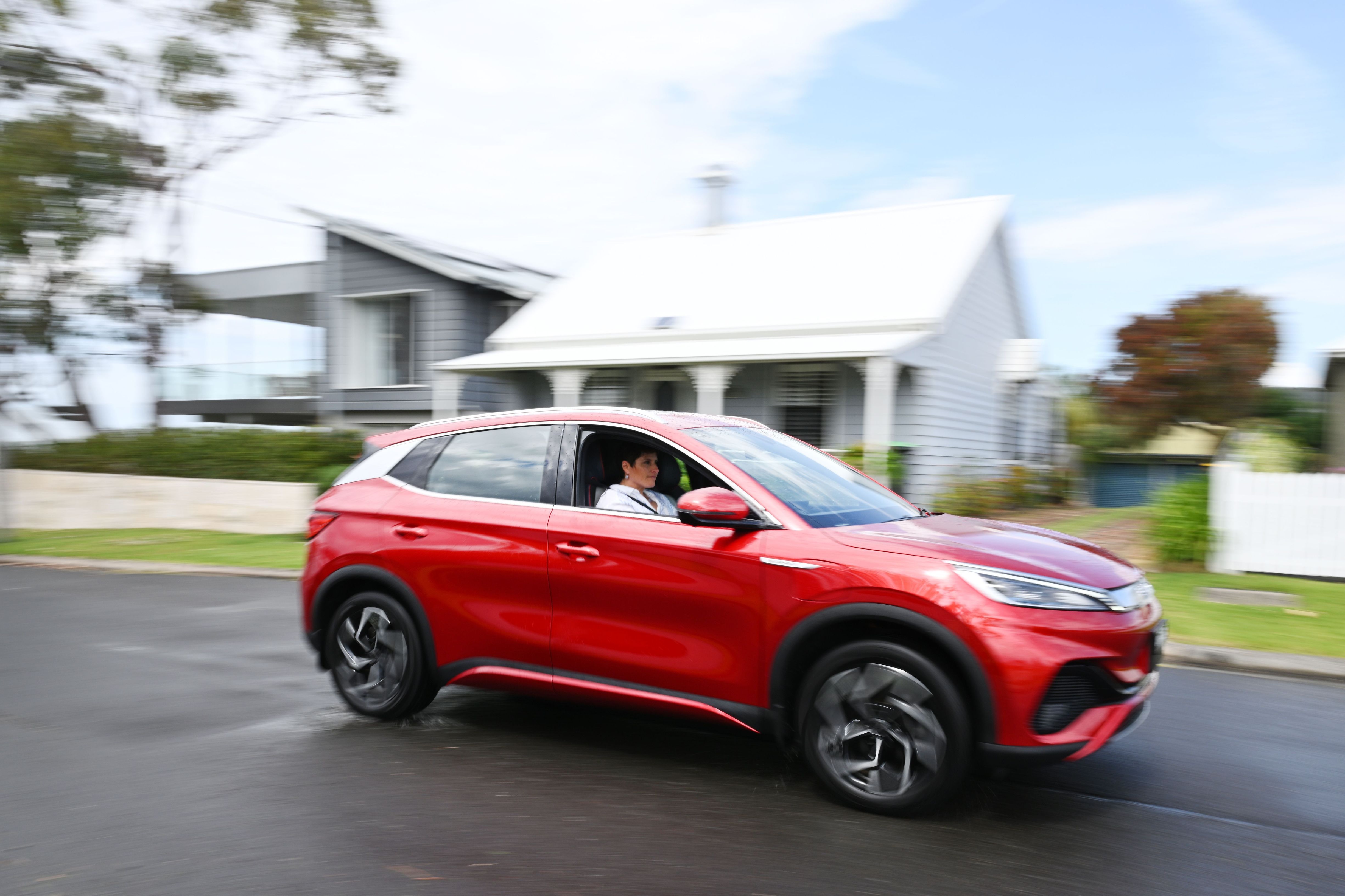 EV owner driving their red BYD vehicle at Kiama on the South Coast of NSW.
