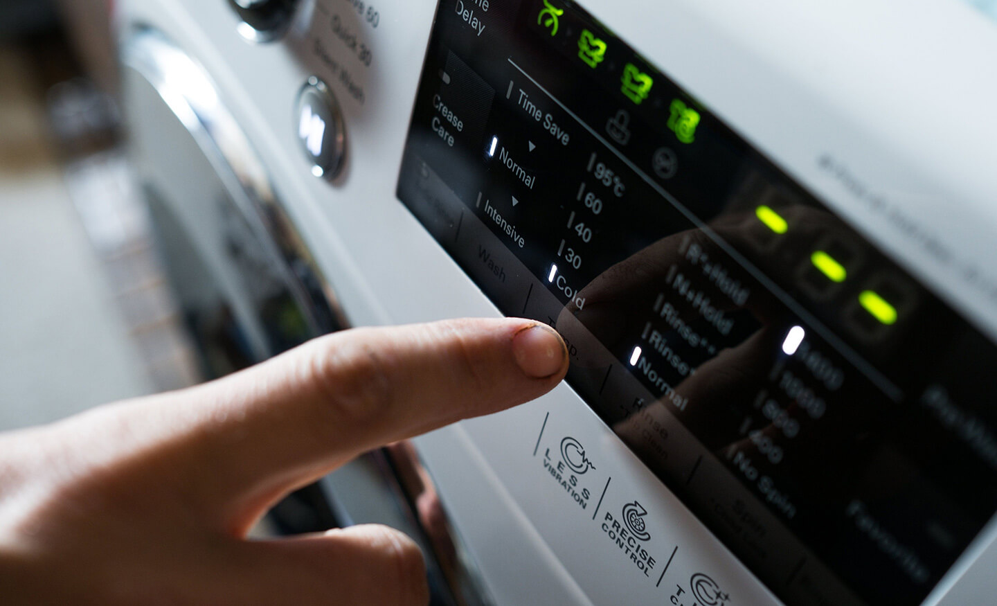 Close up of person using washing machine