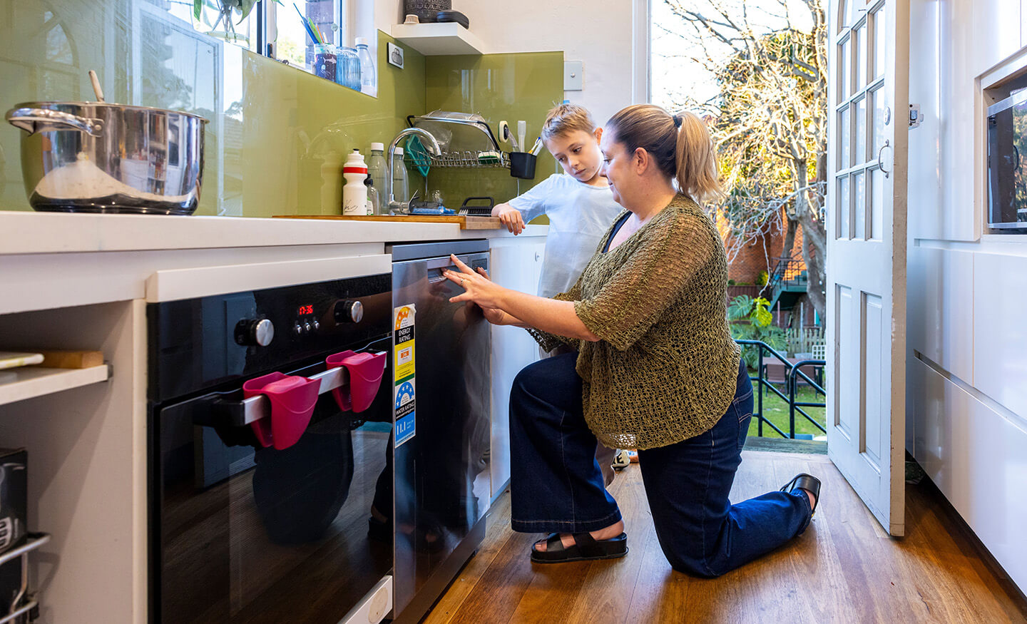 Parent and child using dishwasher