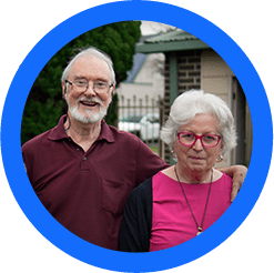 Ken and Karin in front of their home