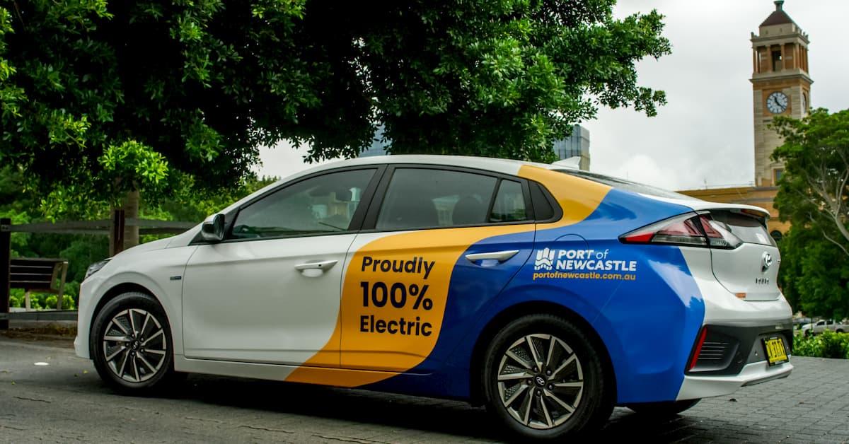An electric vehicle wrapped in port of newcastle stickers