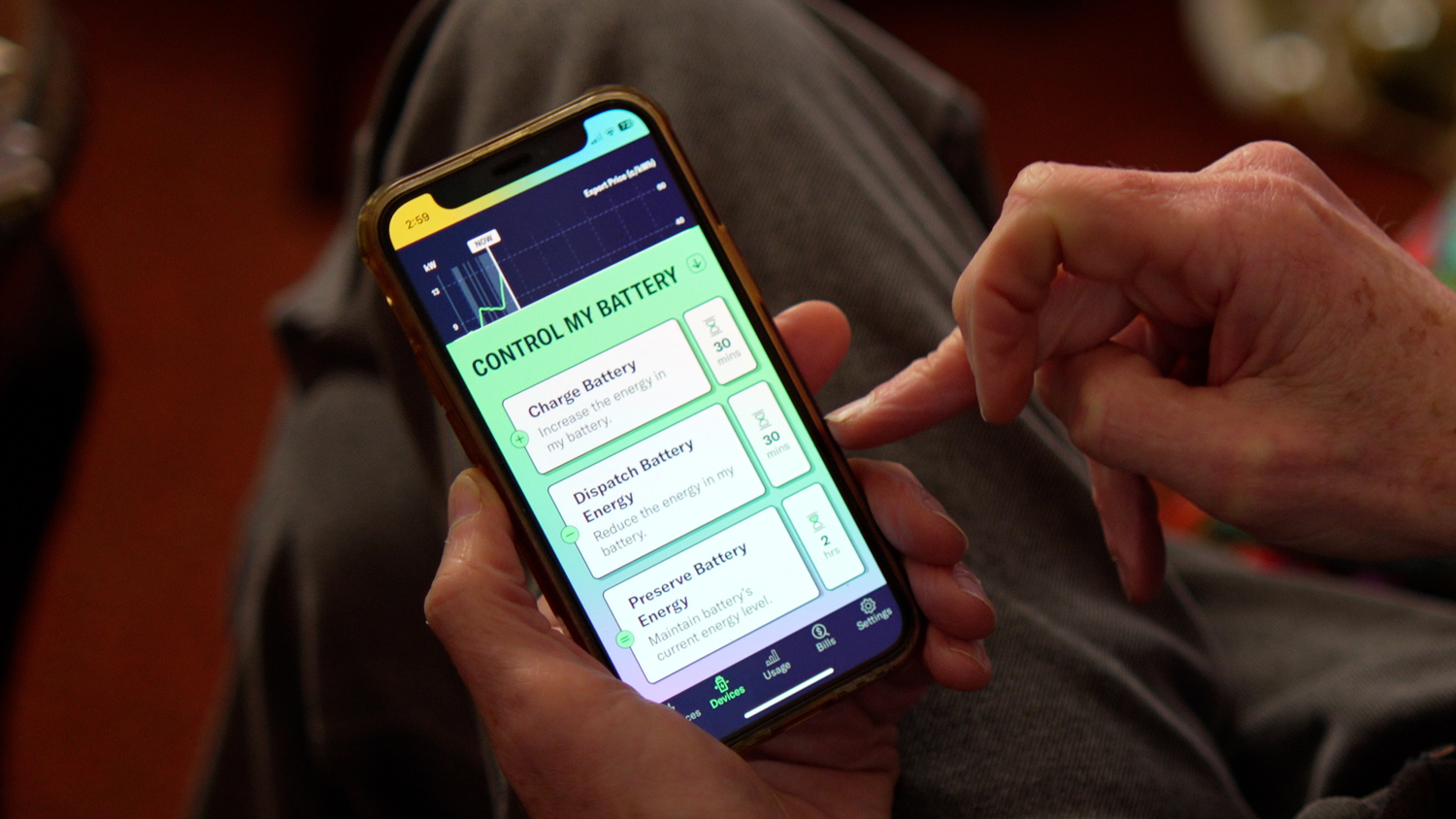 A person holding a mobile phone and using an app