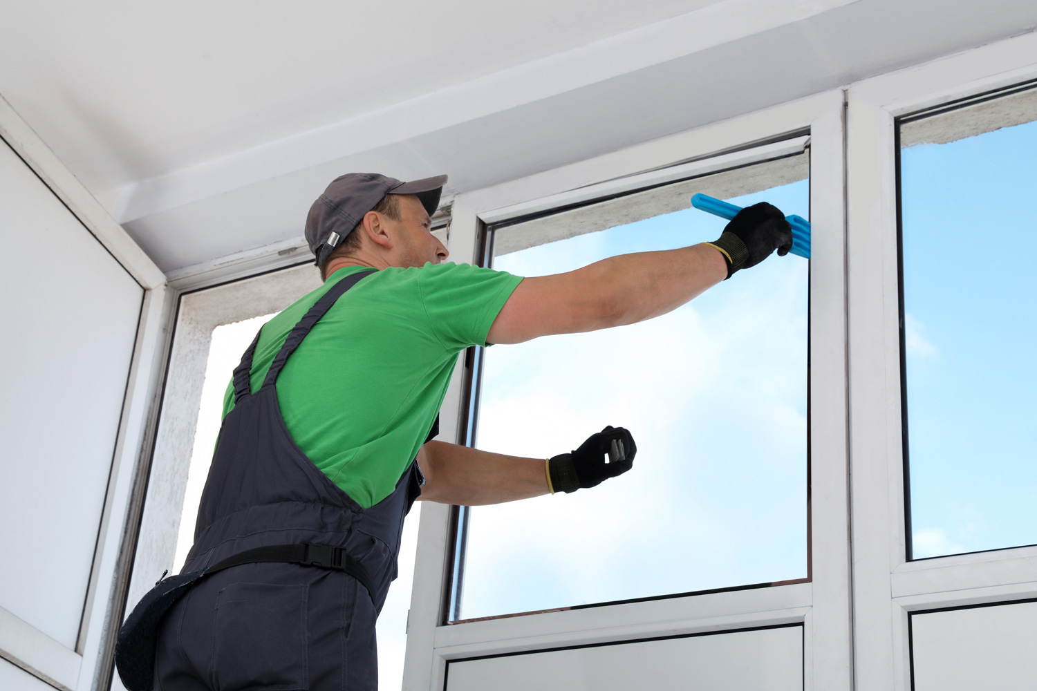 A tradesperson installing a double glazed window