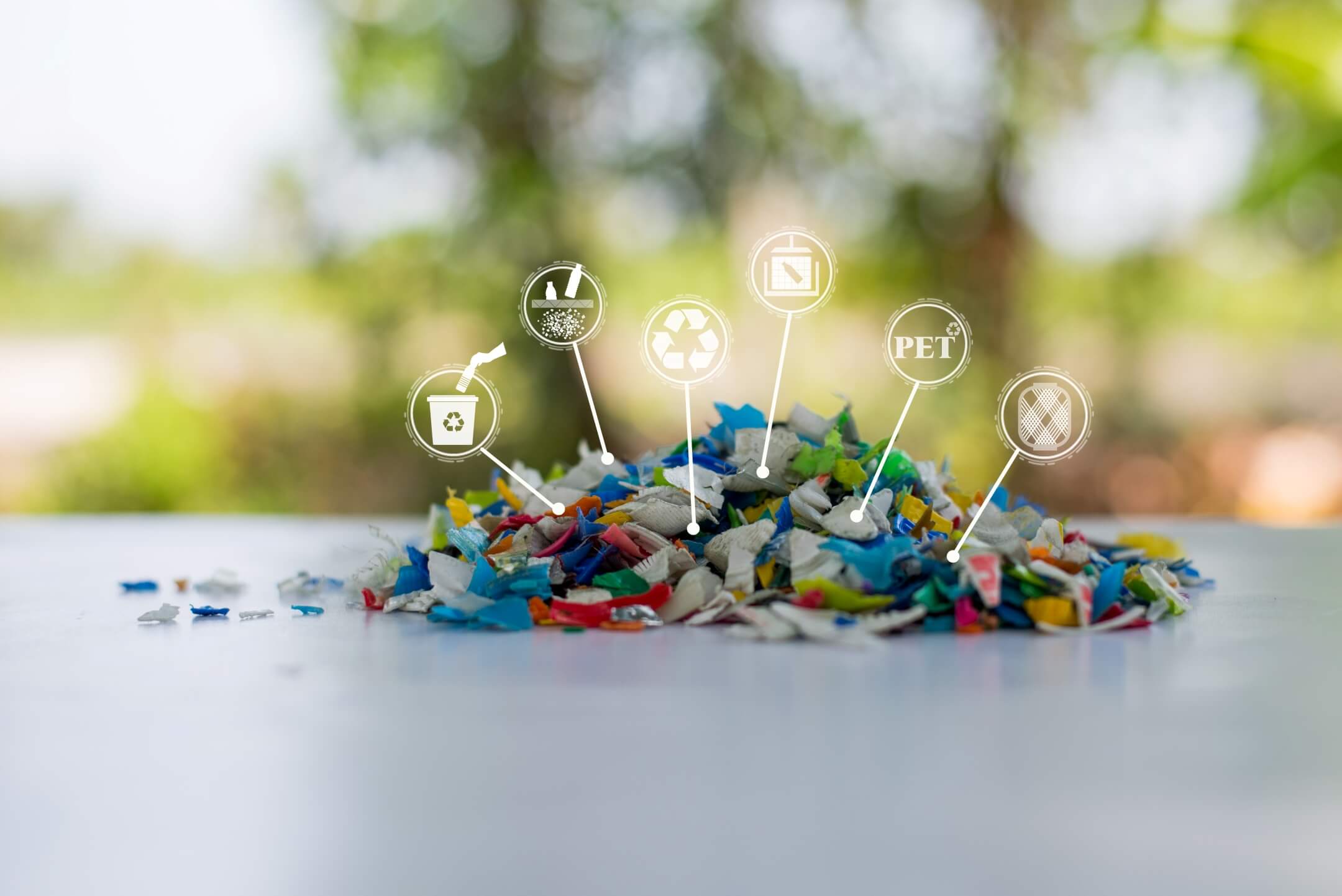 Pieces of differnet kinds of plastic in a pile with labels of what kind of plastic it is.