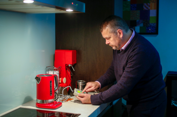 Person checking energy usage in kitchen