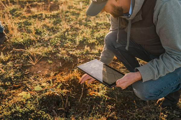 Farmer using technology on the land