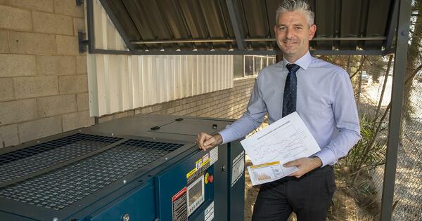 Employee of Tridon standing with air compressor