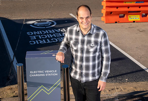 Man standing with EV charger