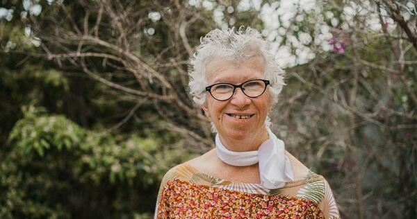 Photo of Catherine outside her home.