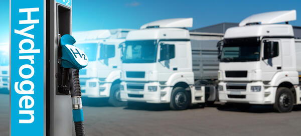 Image of trucks lined up in front of hydrogen pump