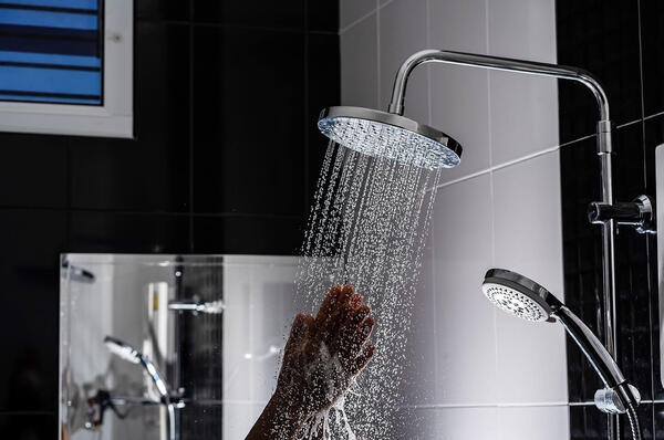 shower with hand reaching into the hot water