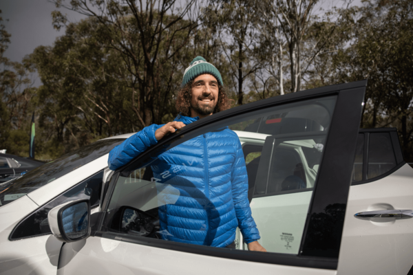 Person standing next to electric vehicle