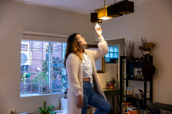 A renter changing a lightbulb